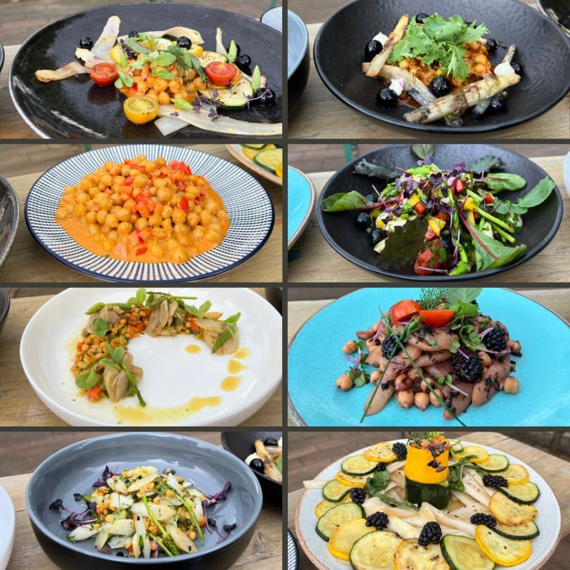 Neun verschiedene Teller mit bunten Spargelgerichten in kreativen Kombinationen, angerichtet mit Zutaten wie Kichererbsen, Salaten, Zucchini, Brombeeren und essbaren Blüten